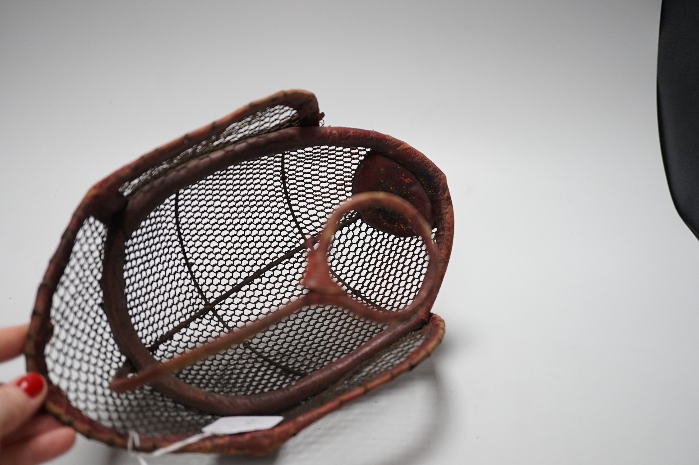 A fencing face mask, 30cms wide